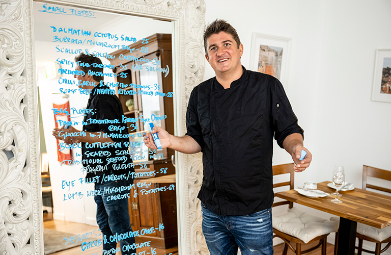 Chef Vedran has a new menu everyday. Chef Vedran Perojevic of croatian restaurant in Matraville writing the menu on the board