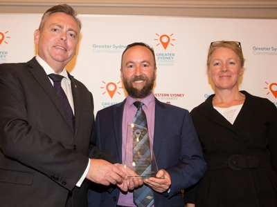 Minister for Planning Anthony Roberts presenting the award to Alan Bright and Joanna Hole from Randwick Council.