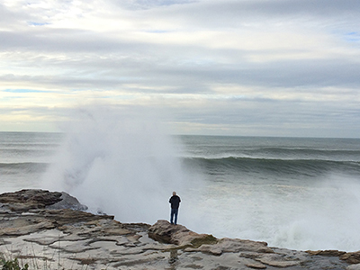 A rock fisherman standing above a choppy set of seas