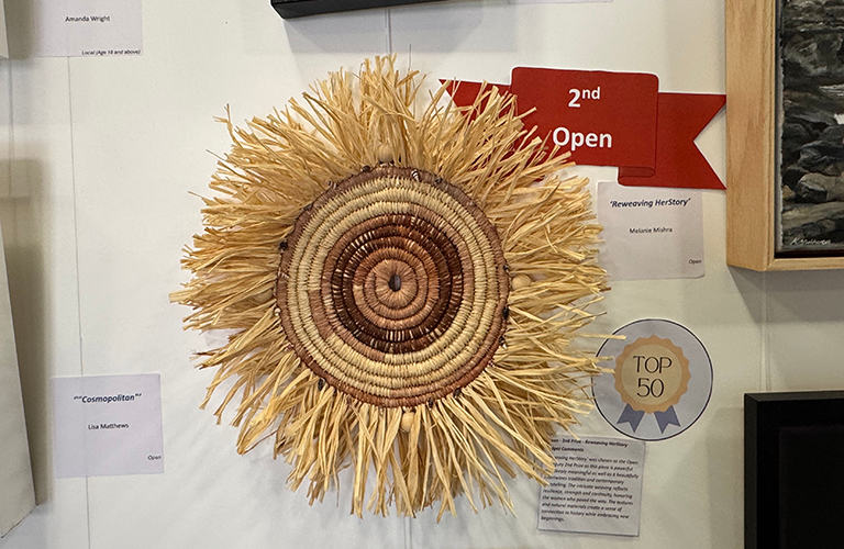 A photo a round straw artwork.