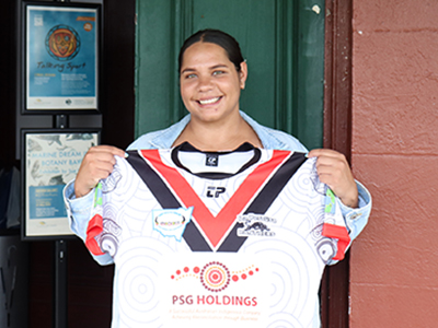 Jasmin Allende holding her La Perouse Panthers  Aboriginal Knockout jersey.