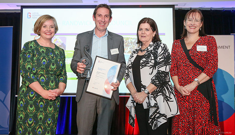 Randwick Council Communication Manager Joshua Hay receiving the award from LG NSW President Cr Linda Scott, LG Minister Shelley Hancock and Landcom's Anna Peterson. 