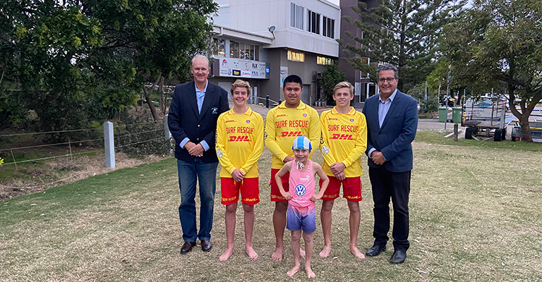 Paul Fownes, President of the South Maroubra Surf Club (left), Mayor Danny Said (right) and some surf life savers and a nipper from the club. The club will benefit from increased storage space in the new building. 